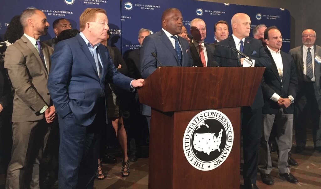 Members of the U.S. Conference of Mayors scan the crowd after a reporter asked who among them was supporting Donald Trump for president. (William W. Savage III)