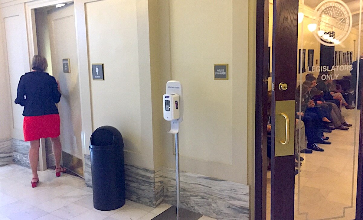 A state representative enters a restroom typically reserved for lawmakers and staff. Pages were told they could use that restroom on Monday, April 10, 2017, because "cross-dressers" were in the building. William W. Savage III)