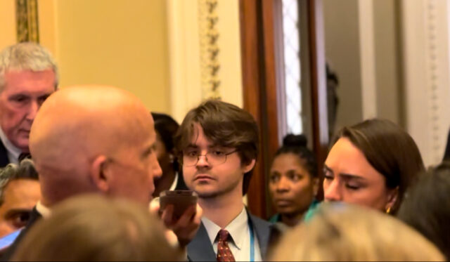NonDoc Eagleson Photo NonDoc reporter Kevin Eagleson participates in a media scrum outside of the House of Representatives.